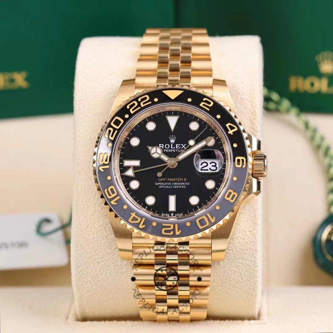 Rolex GMT-Master II m126718grnr 0001, front view on cushion with black dial and gold bracelet.