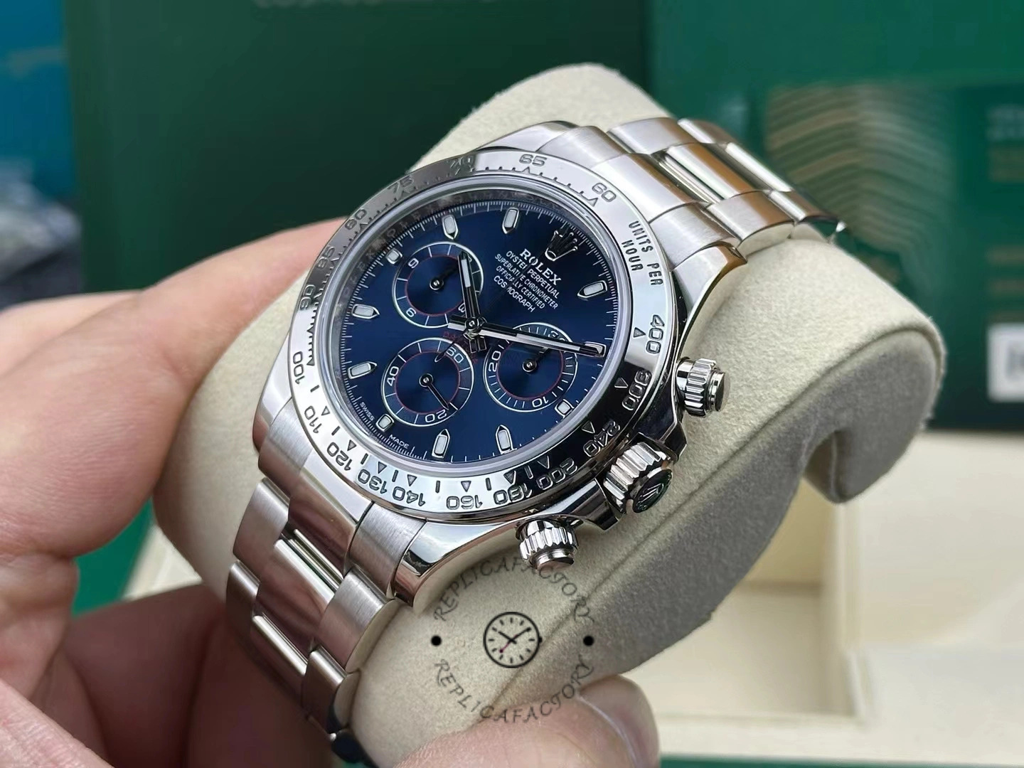 Cushion shot of the Rolex Cosmograph Daytona 116509 40MM, blue dial centered on steel bracelet.