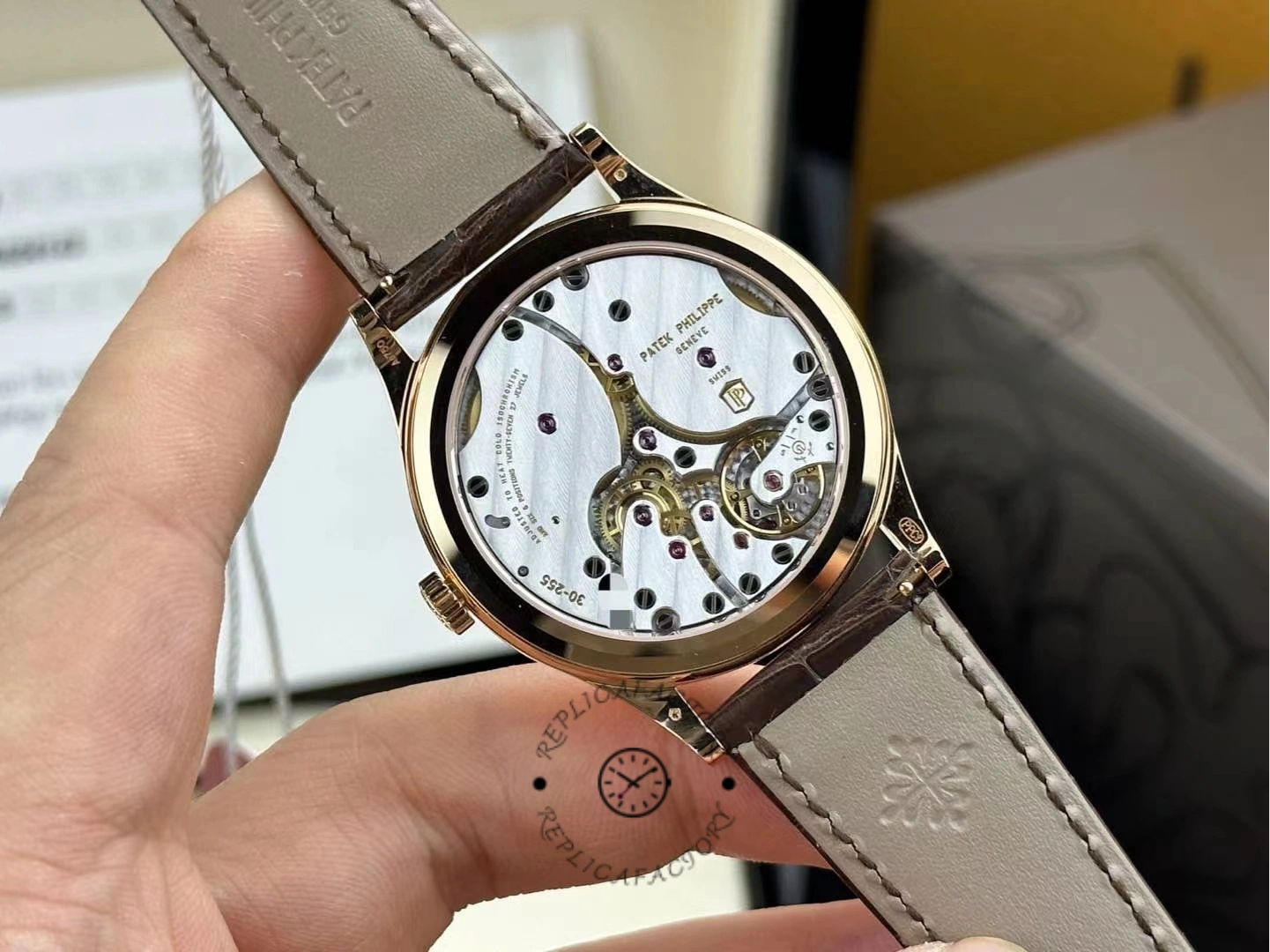 Caseback close-up view of Patek Philippe Calatrava 6119R-001 showing movement through sapphire back and rotor.