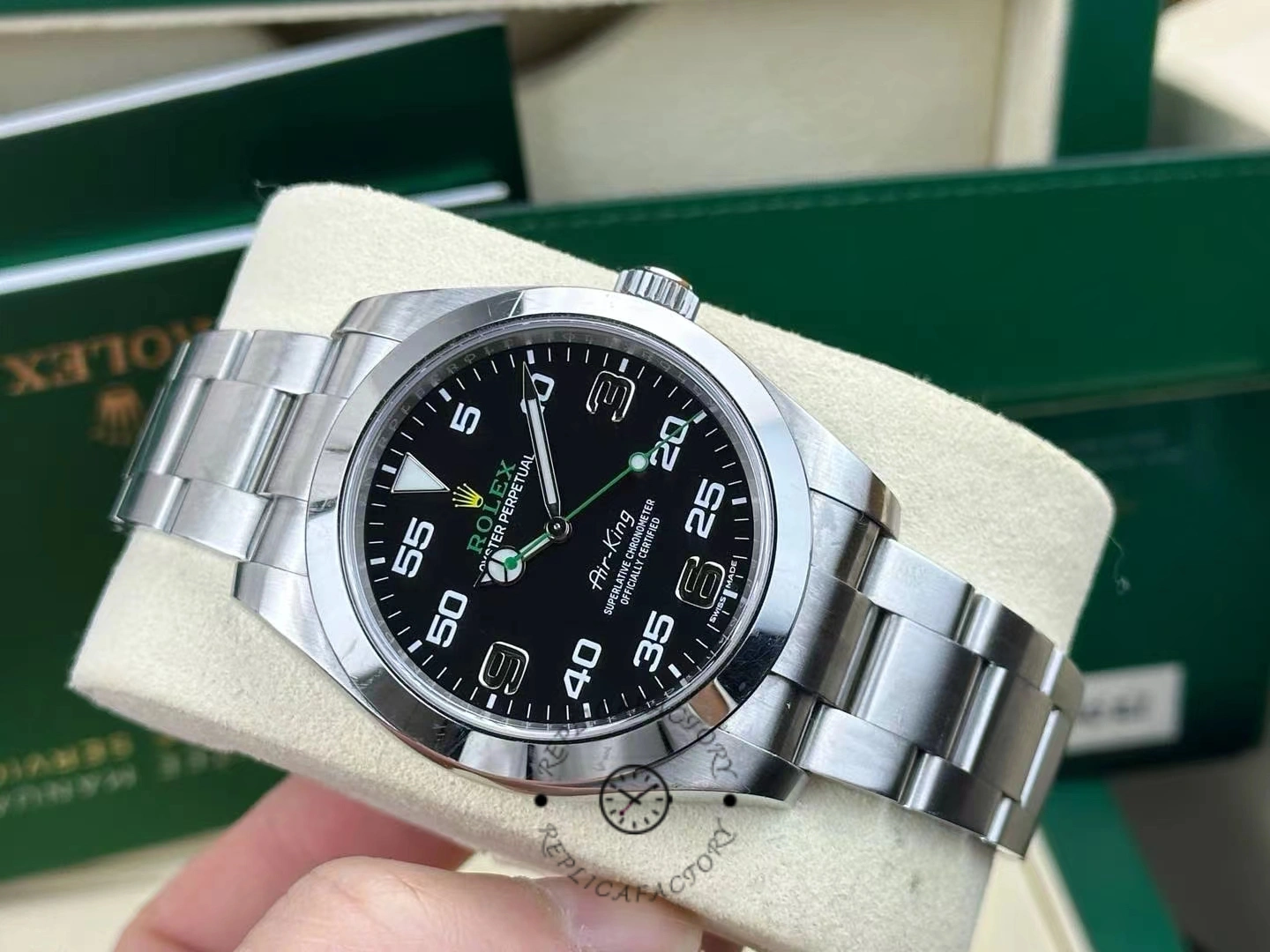 Rolex Air-King 116900, black dial front view with green Rolex box in background.