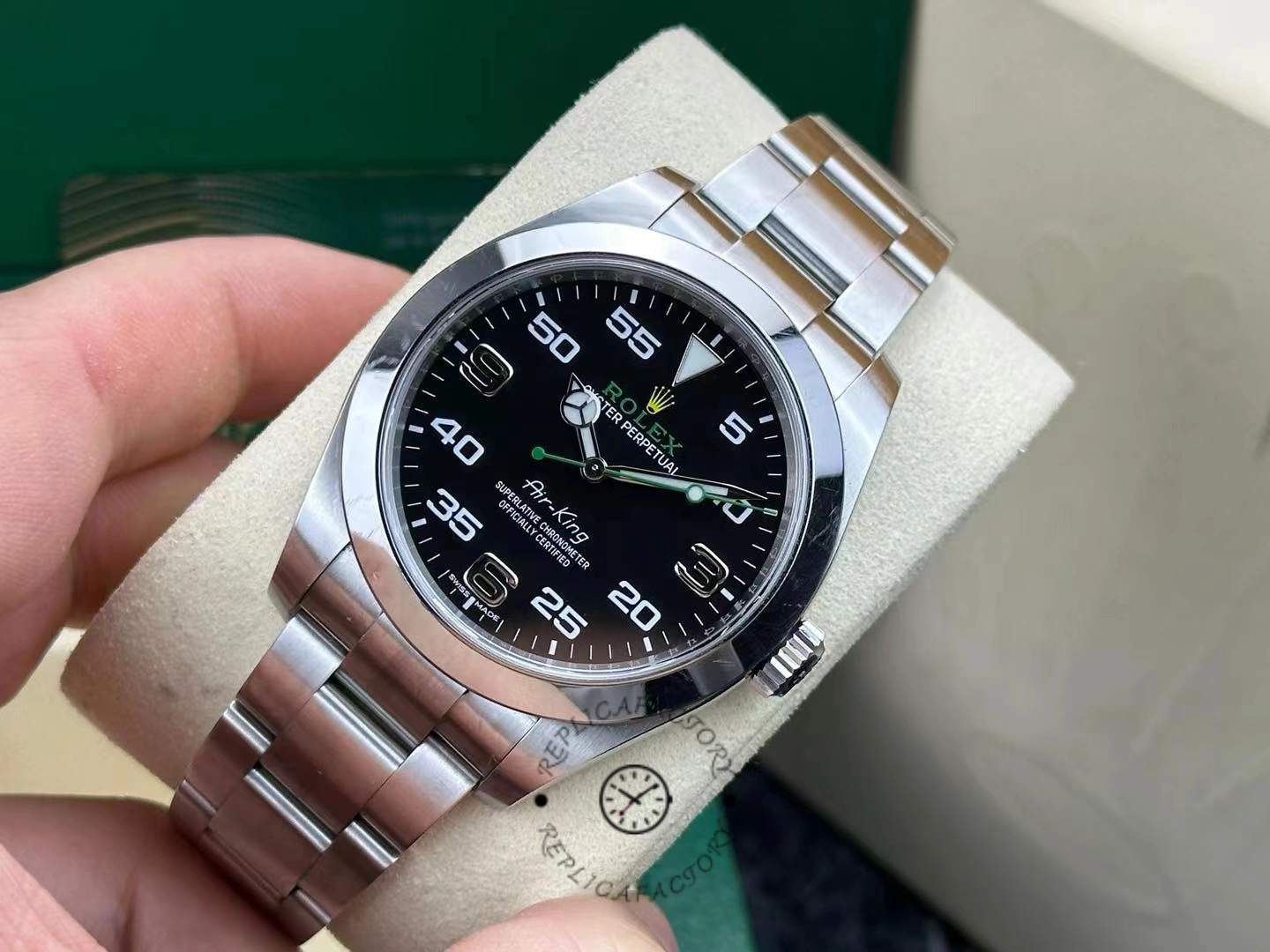 Rolex Air-King 116900, angled hand-held view showing bezel, crown, and bracelet.