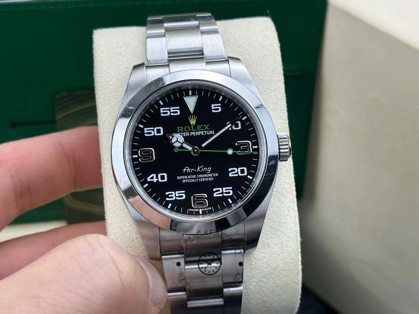 Rolex Air-King 116900, black Arabic dial close-up, Oyster bracelet, on cushion.