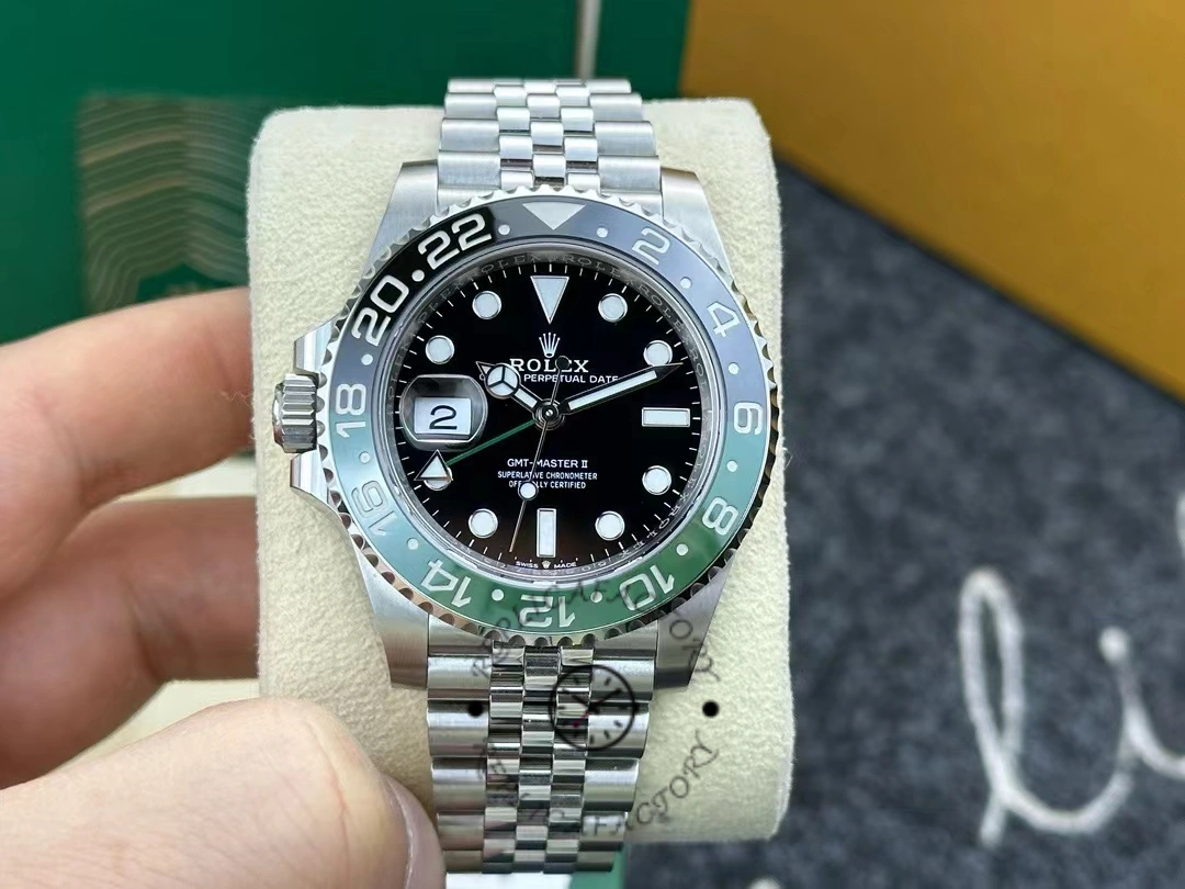 Rolex GMT-Master II 126720VTNR on cushion, front view with green-black bezel and Jubilee bracelet.