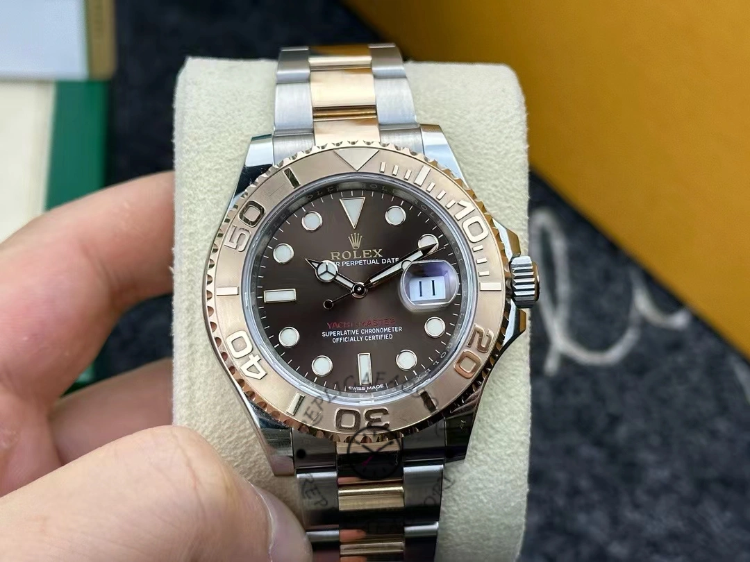 Handheld front view of Rolex Yacht-Master 116621, chocolate dial, two-tone bracelet.