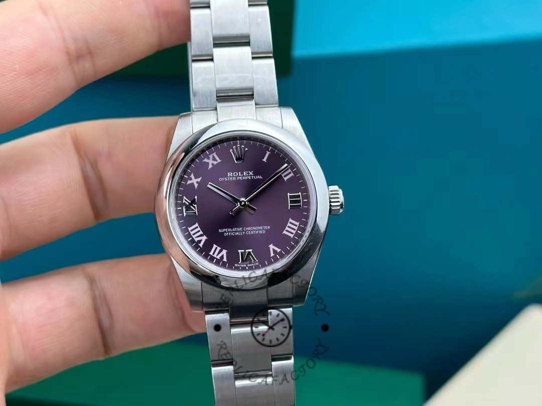 Rolex Oyster Perpetual 177200 hand-held view, grape red dial and bracelet shown.