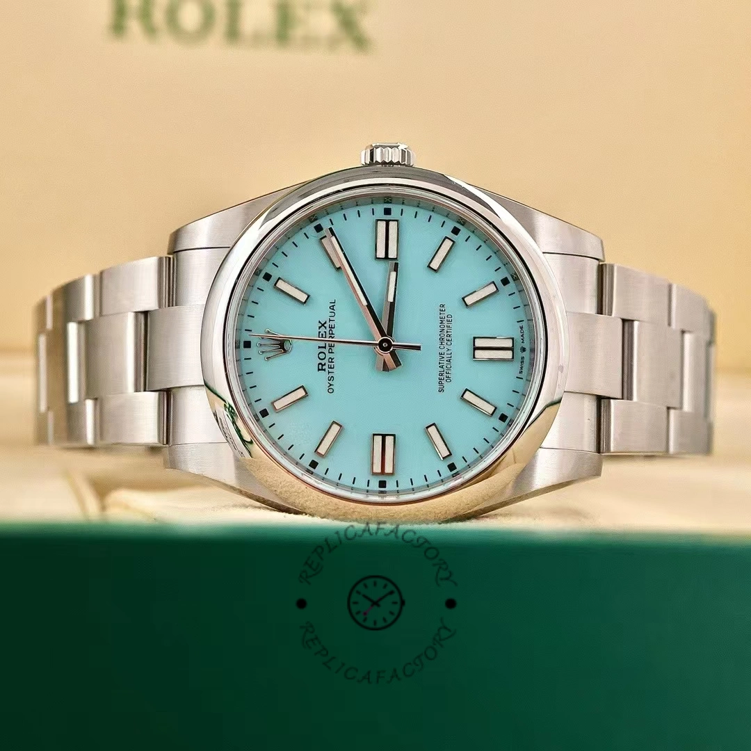 Rolex Oyster Perpetual 41 m124300 0006, front view near green box showing turquoise dial.
