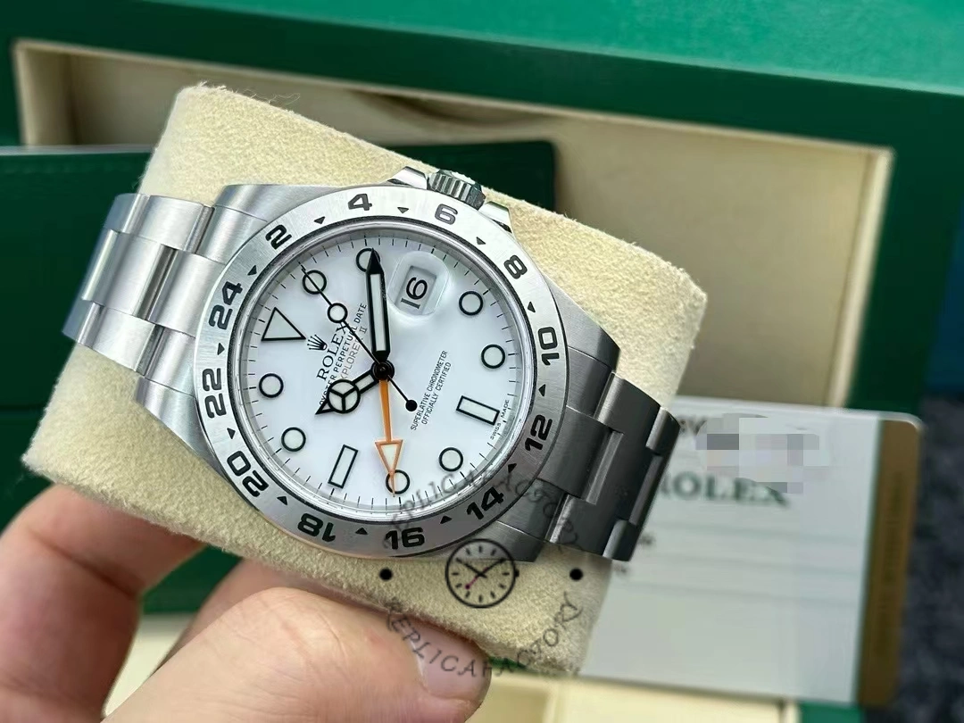 Rolex Explorer II m226570 0001 on cushion near box, showing bracelet and dial details.