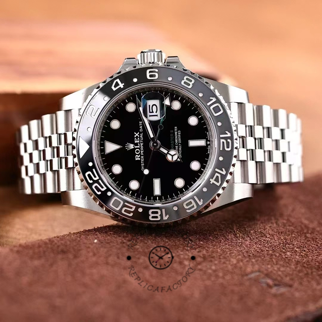 Rolex GMT-Master II M126710GRNR 0003, hand-held front view showing black dial and bezel.