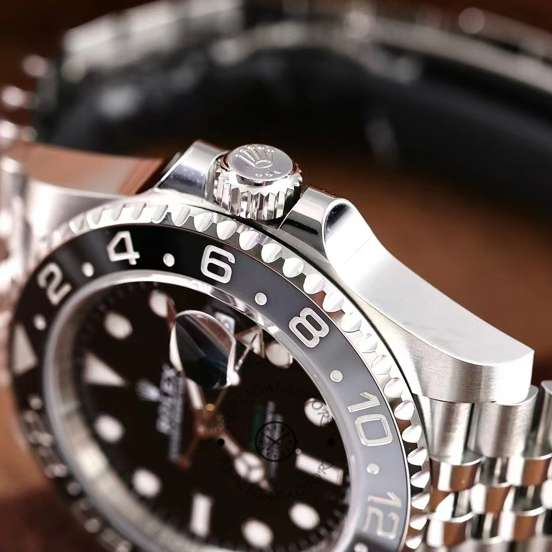 Rolex GMT-Master II M126710GRNR 0003, side close-up showing crown guards and bezel edge.