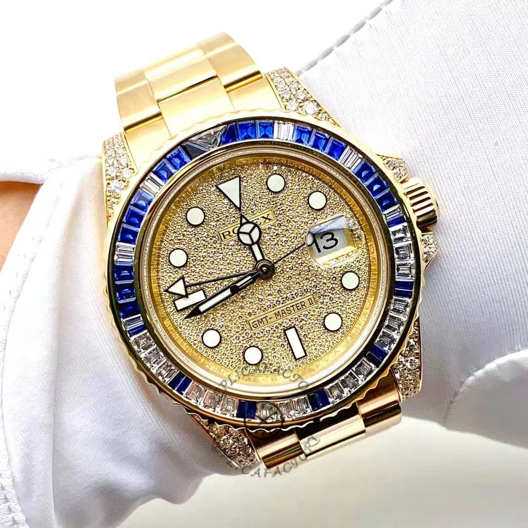 Wrist shot of the Rolex GMT-Master II 116758, yellow gold with pave dial and blue bezel.