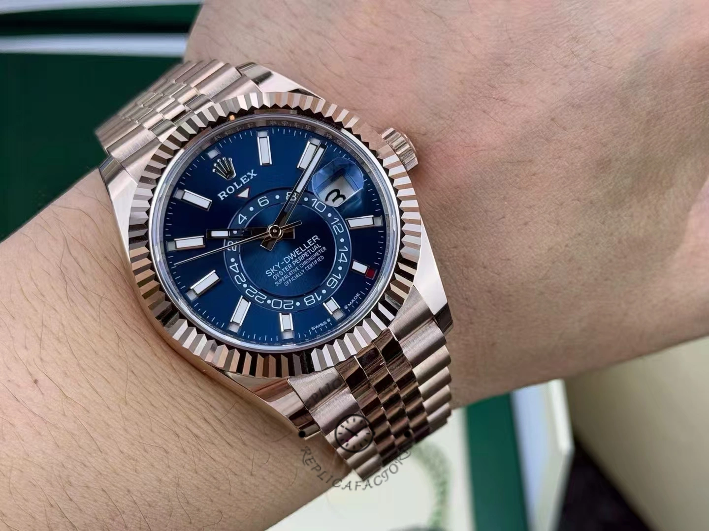 Wrist shot of the Rolex Sky-Dweller m336935 0005 showing blue-green dial on Everose bracelet.
