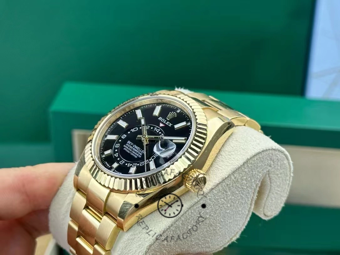 Rolex Sky-Dweller M336938-0002, watch on cushion showing gold case and black dial.