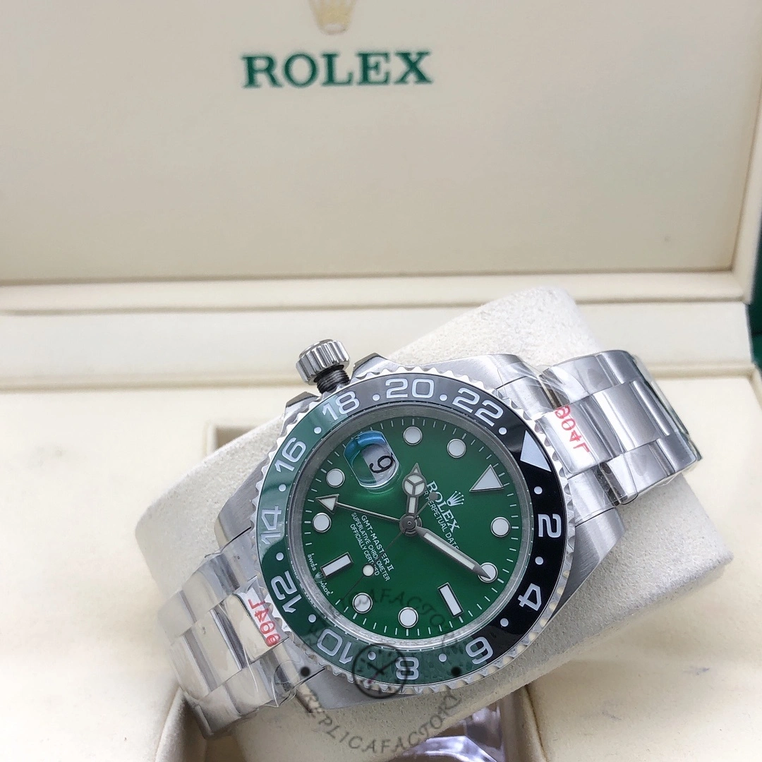 Rolex GMT-Master II m126729VTNR 0001 angled view in box, green dial and bezel, bracelet visible.