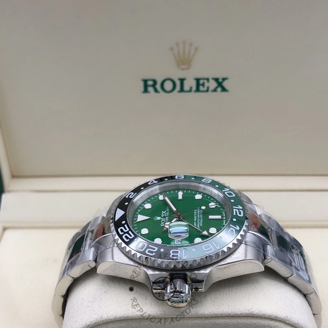 Rolex GMT-Master II m126729VTNR 0001 top view in box, green dial and bezel, case profile shown.