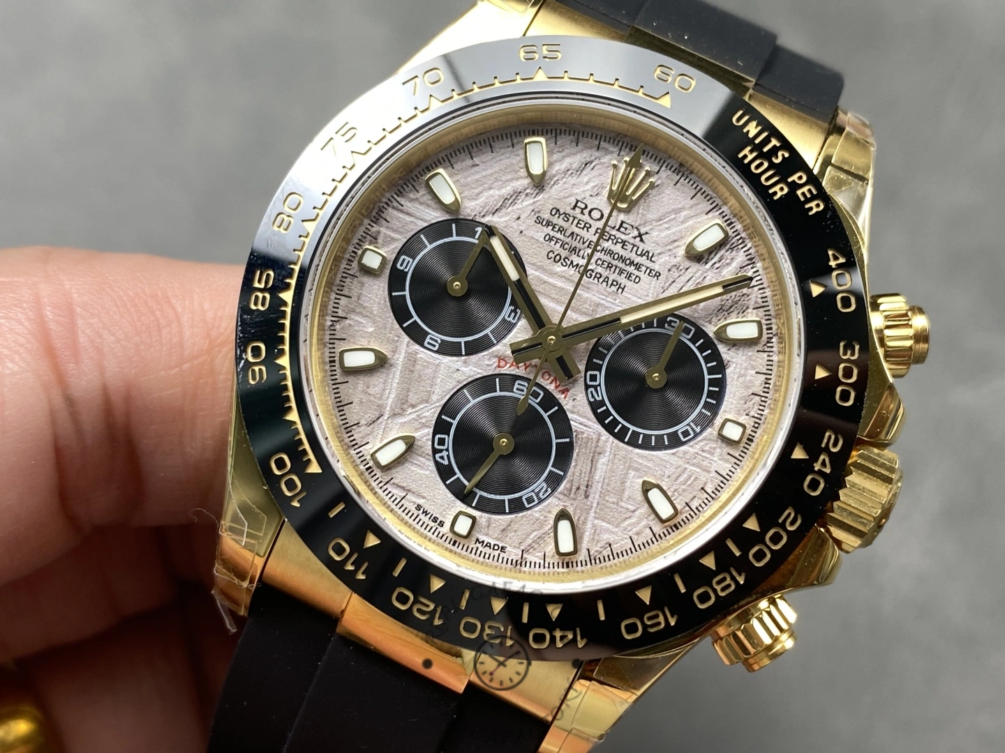 Rolex Daytona 126518LN 0016, front view in hand showing chronograph subdials and luminous hour markers.