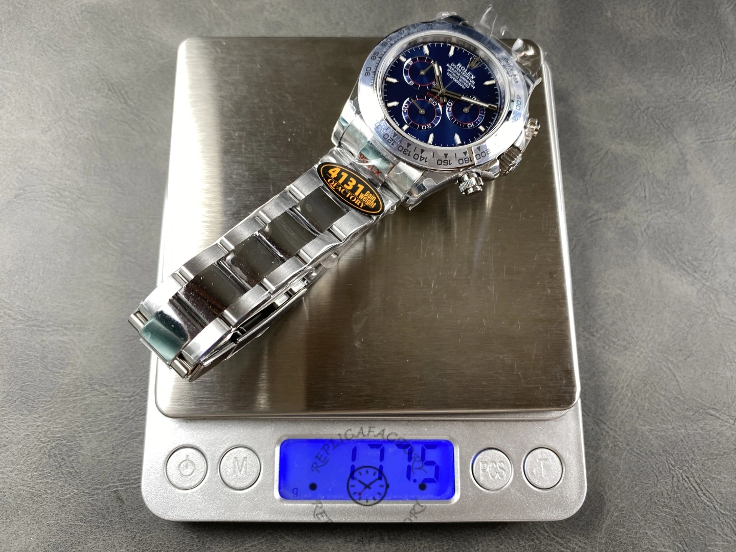 Rolex Daytona m126509-0005, watch on scale showing weight.