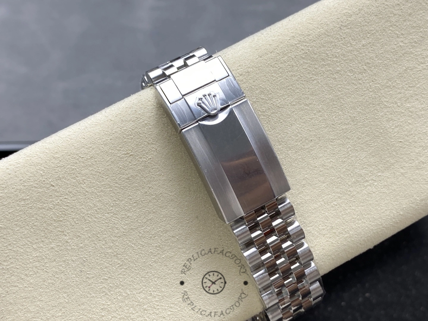 Rolex GMT-Master II 126720, bracelet clasp view on cushion showing clasp closed.