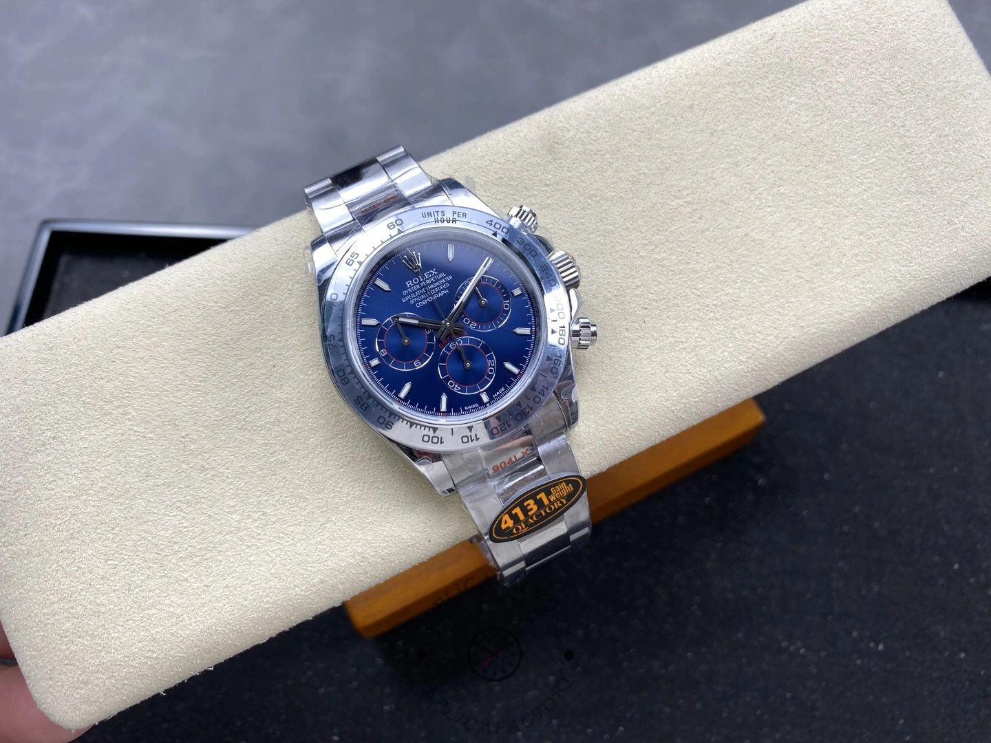 Rolex Daytona m126509-0005, blue dial, wrist shot on cushion.