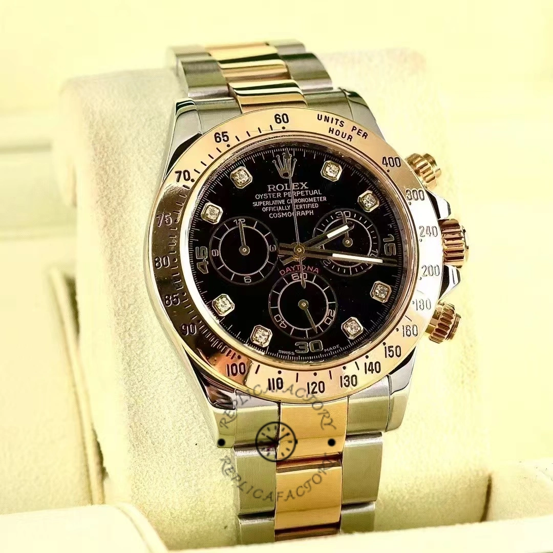Rolex Daytona 116523 on stand, full front view, black diamond dial and two-tone bracelet.