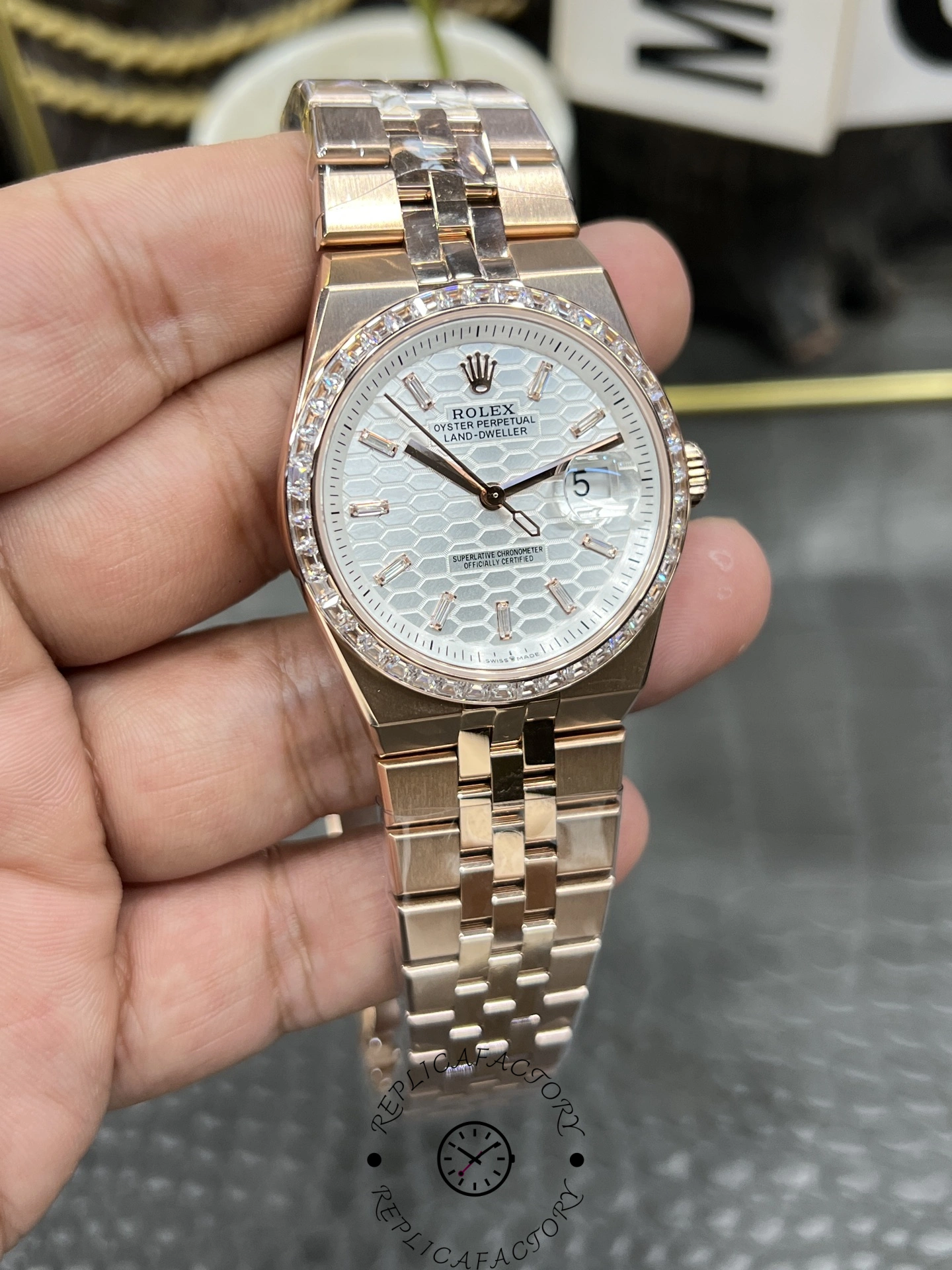Close-up front view of Rolex Land Dweller m127385tbr 0003 Replica with silver dial and rose gold bracelet.