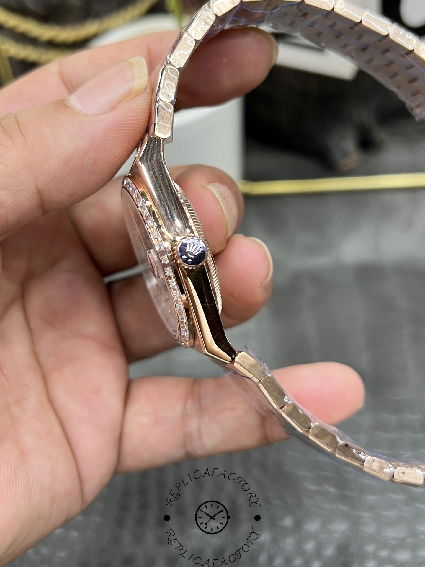 Side view of Rolex Land Dweller m127385tbr 0003 Replica displaying rose gold case and crown details.