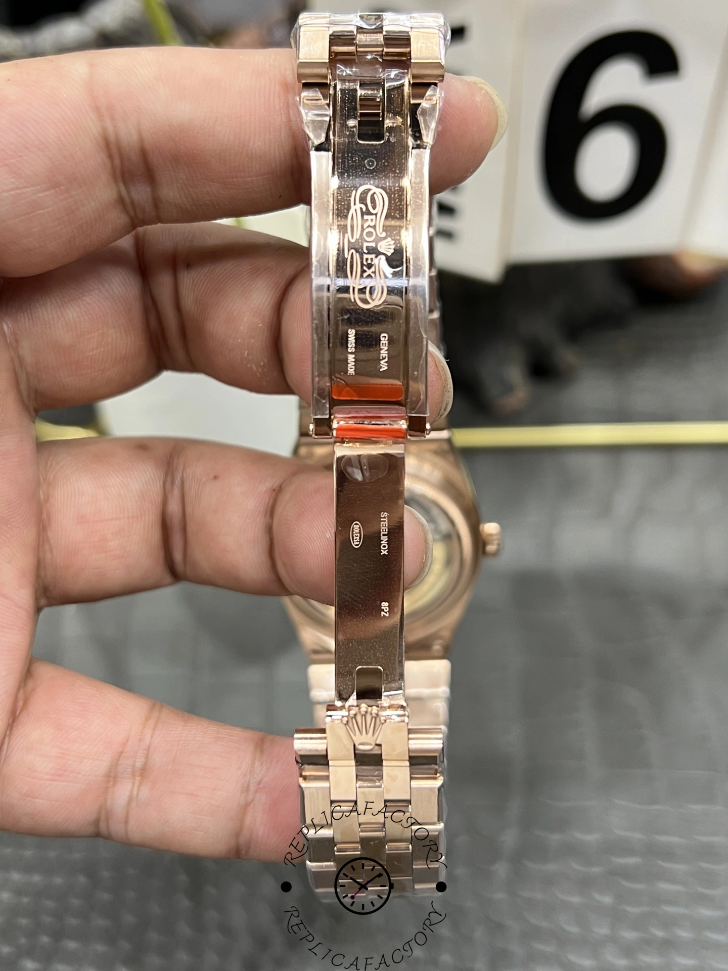 Clasp and bracelet detail of Rolex Land Dweller m127385tbr 0003 Replica in polished rose gold finish.