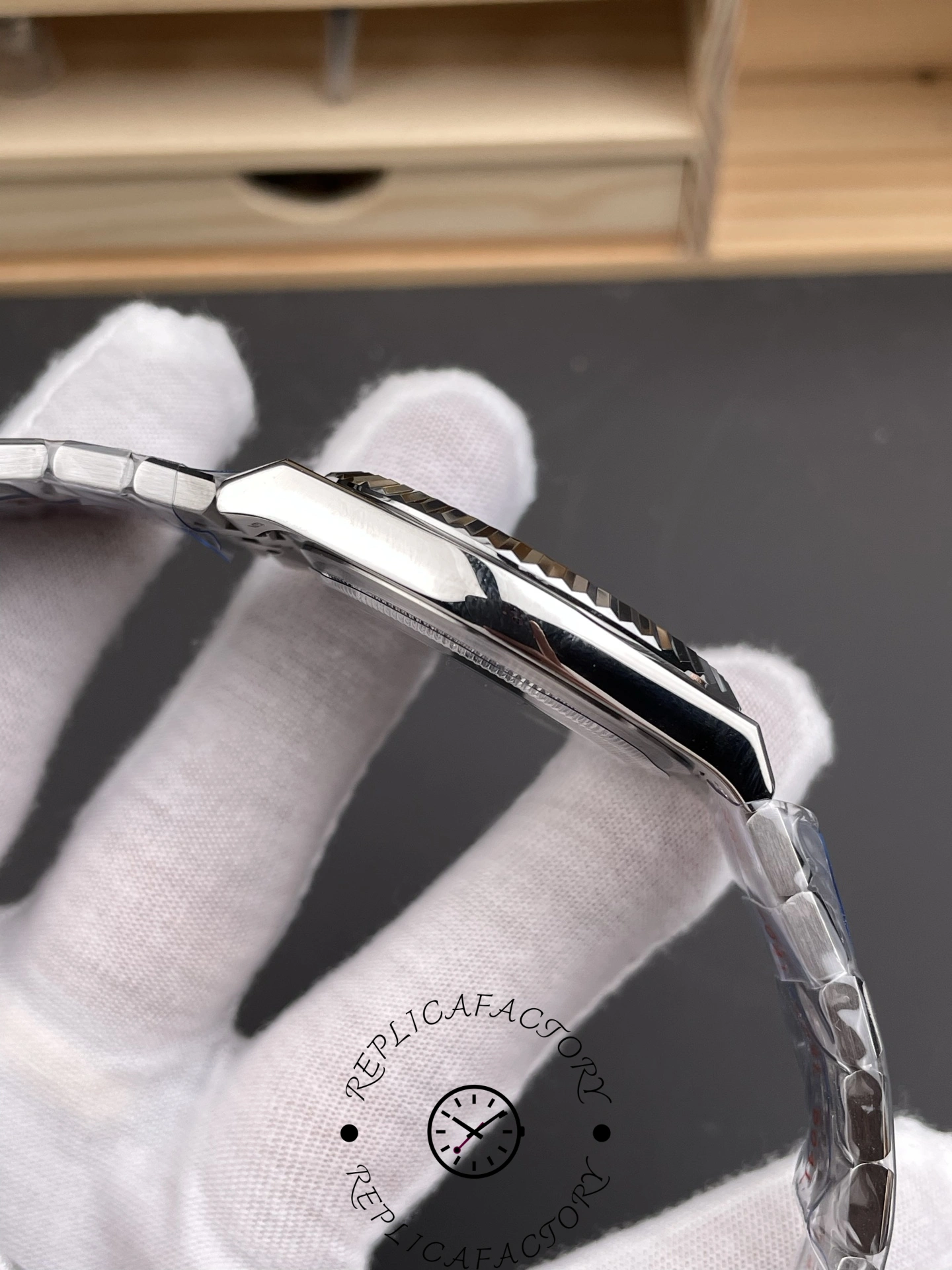 Side angle of Rolex Land-Dweller 40 127336-0001 Replica highlighting polished case side and lugs.