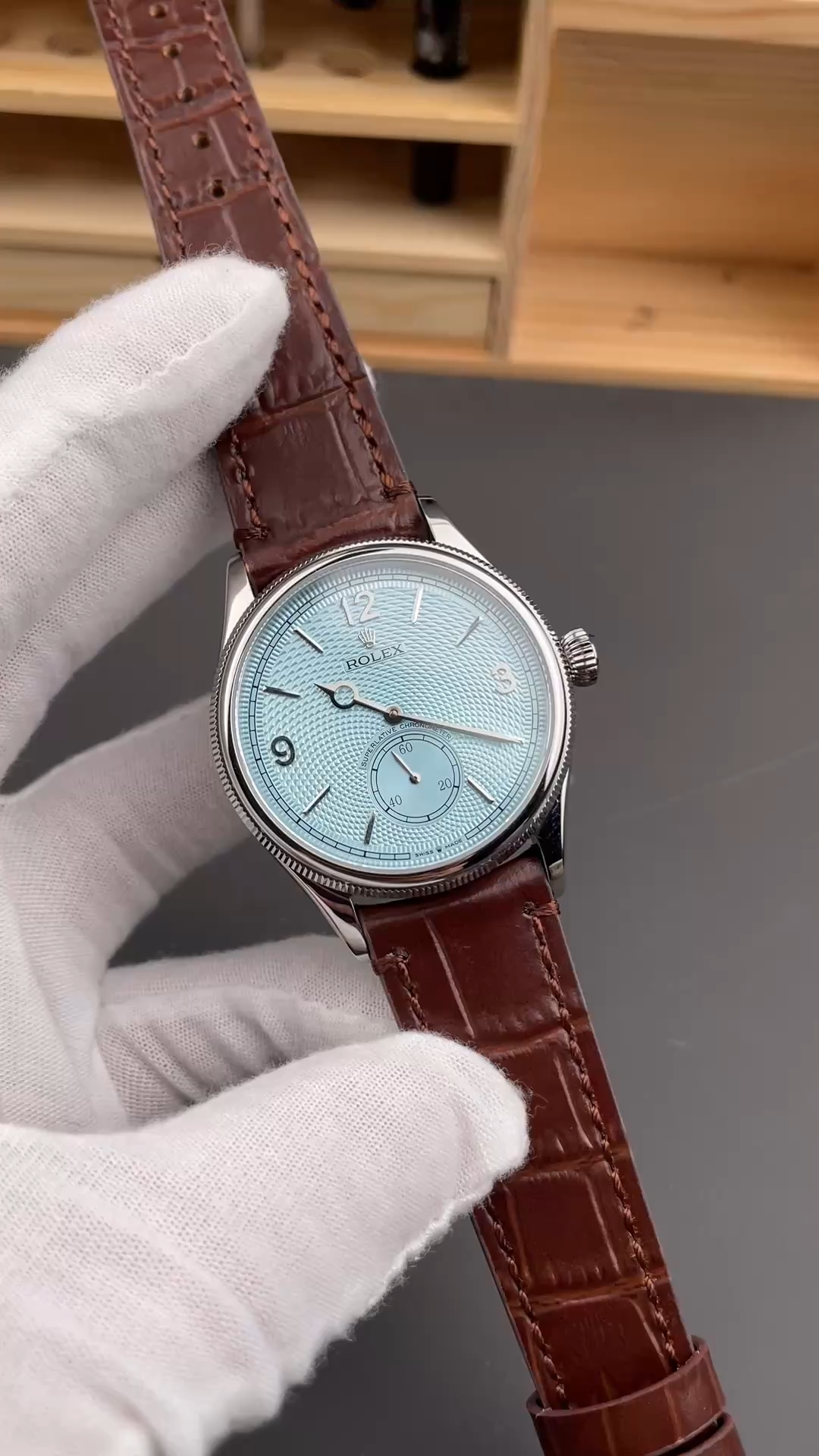 Video showing the Rolex 1908 52506-0002 replica held in hand, highlighting dial texture and leather strap.
