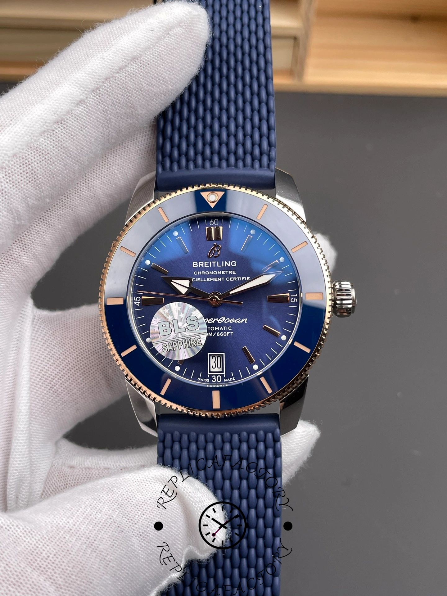Breitling UB3112161C1S1, front view highlighting blue dial, bezel markers, and stainless-steel case.