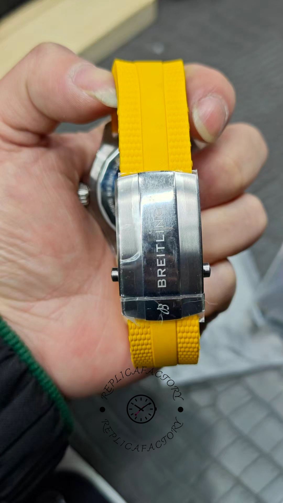 Strap buckle view of Breitling Superocean Automatic A17375211B2S4 showing yellow rubber strap and clasp.