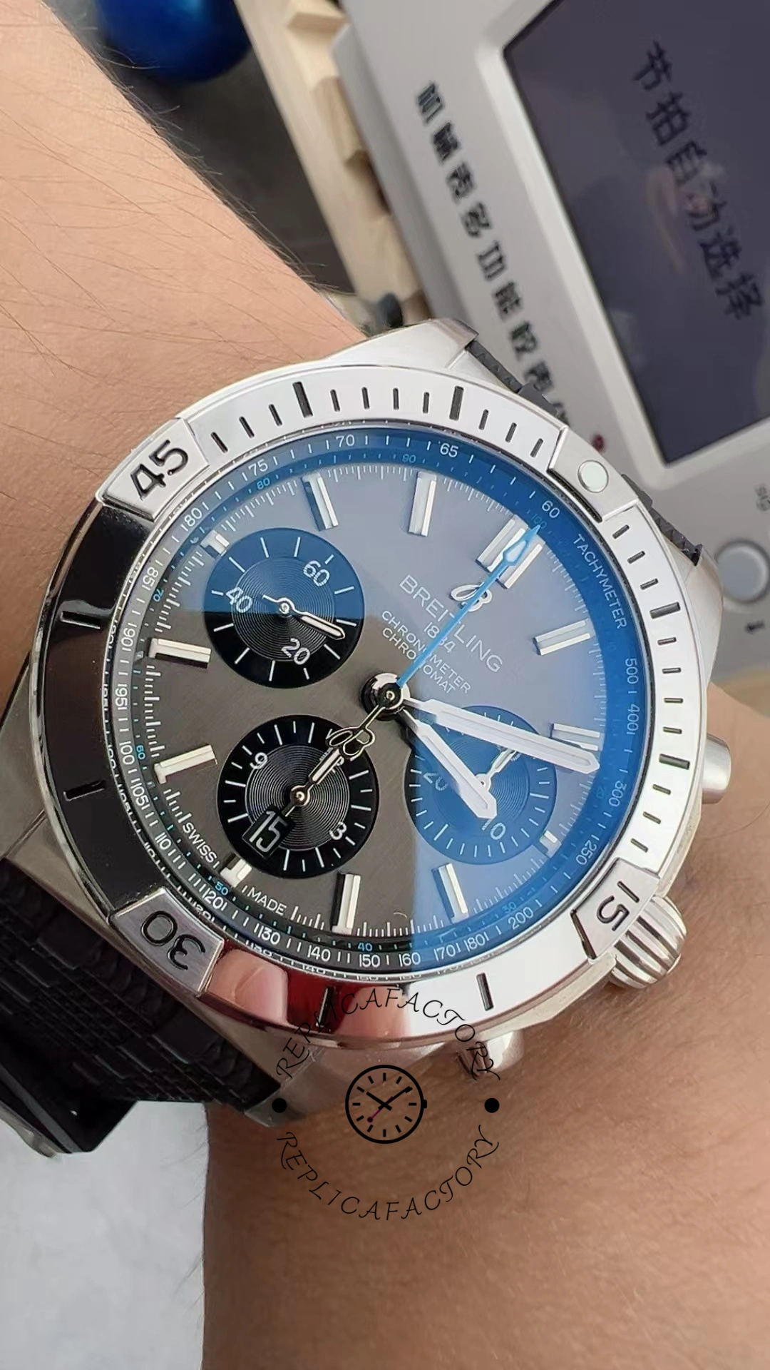Wrist shot of Breitling Chronomat B01 EB0134101M1S1 showing blue dial and bezel in natural light.