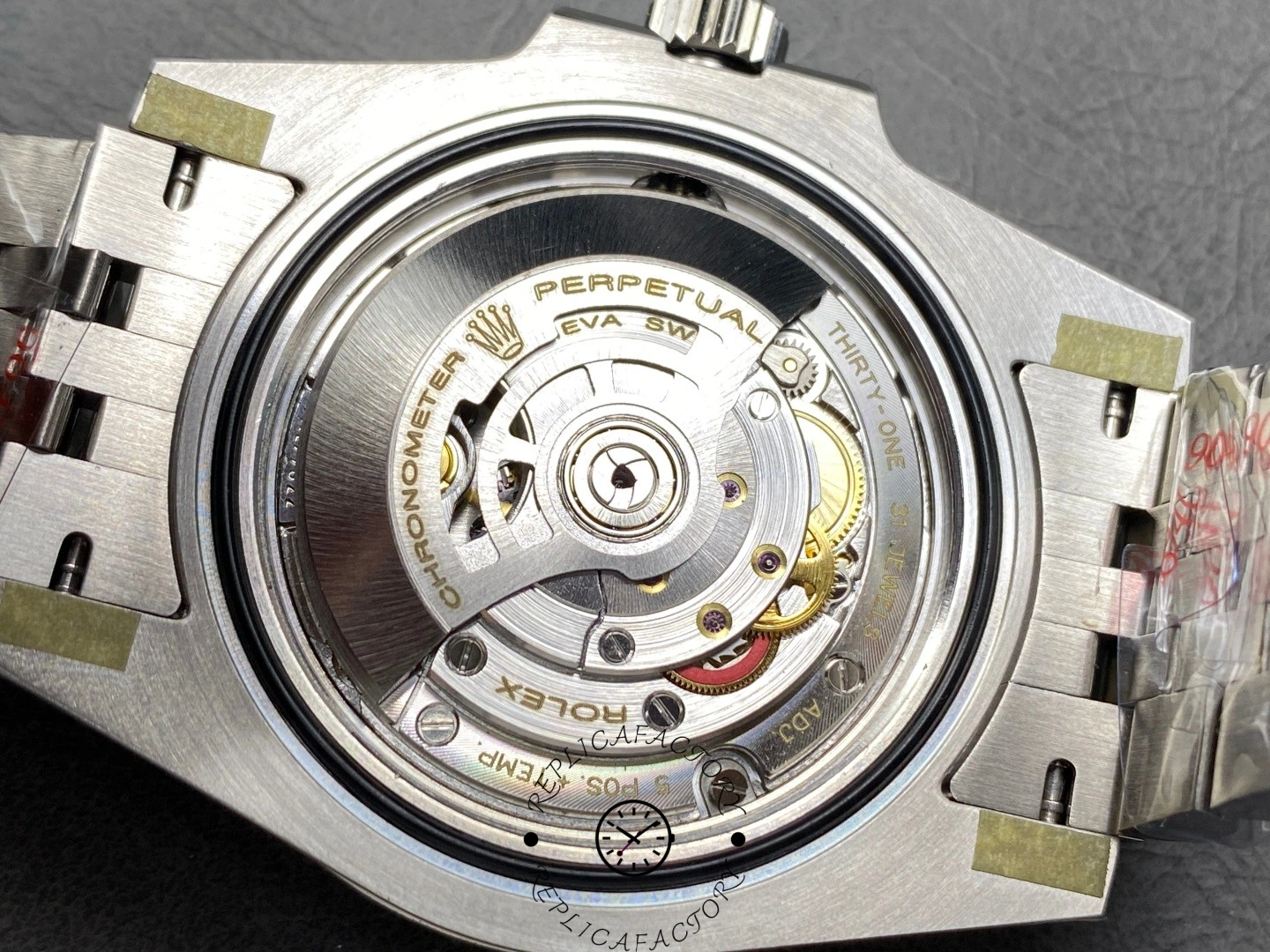 Rolex GMT-Master II 126710BLNR movement close-up, rotor detail inside open case back.