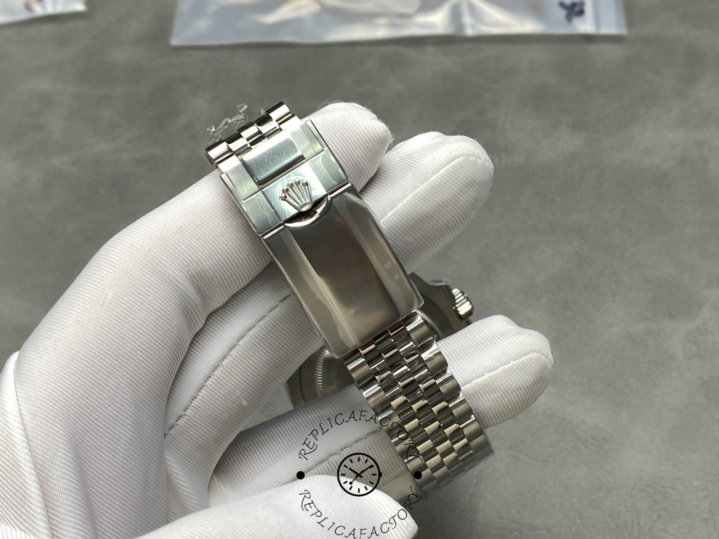 Rolex GMT-Master II 126710BLNR clasp-side view, Jubilee bracelet and clasp detail, held in glove.