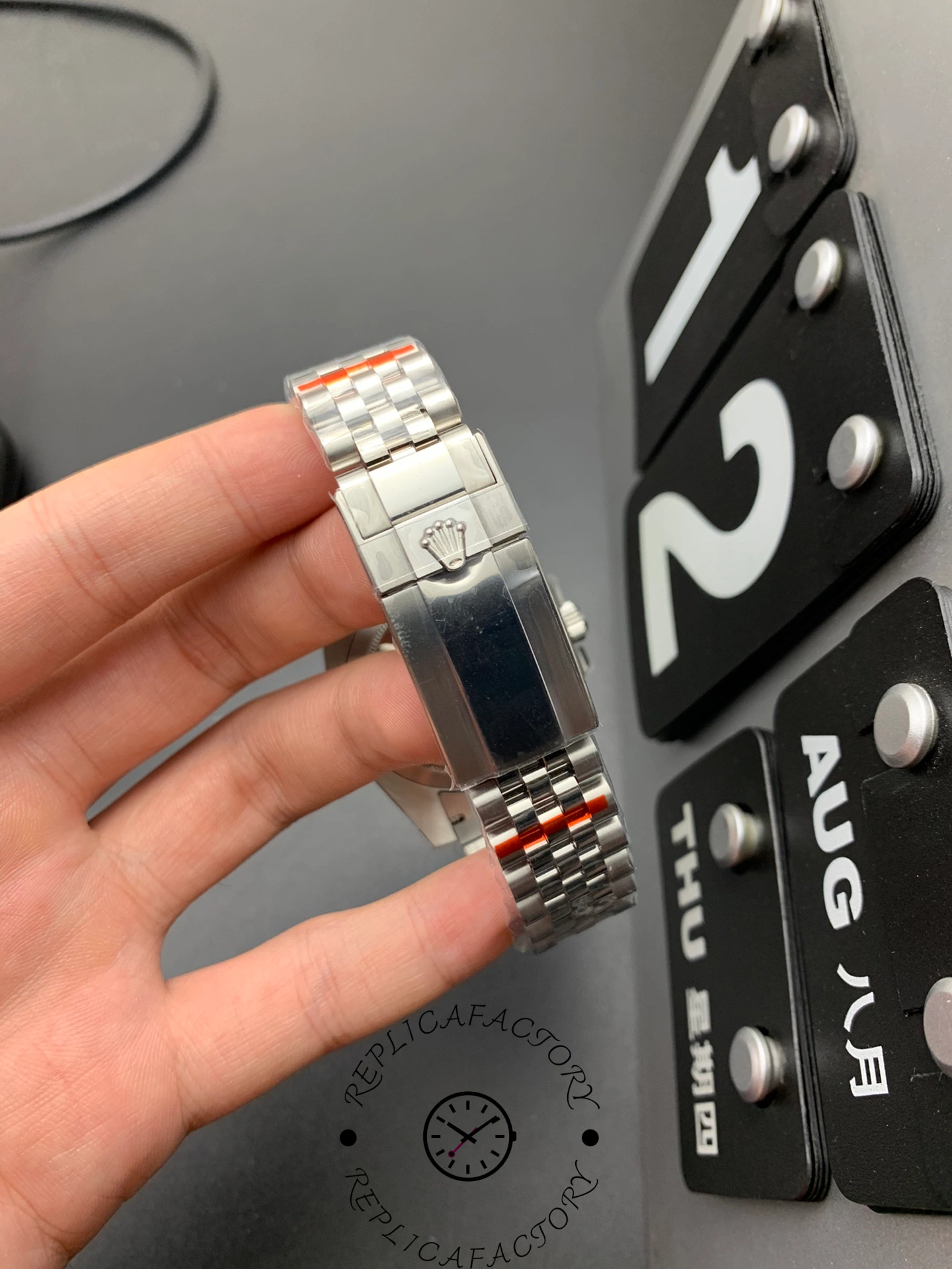 Rolex GMT-Master II 126710BLNR bracelet held in hand, Jubilee links and clasp visible.