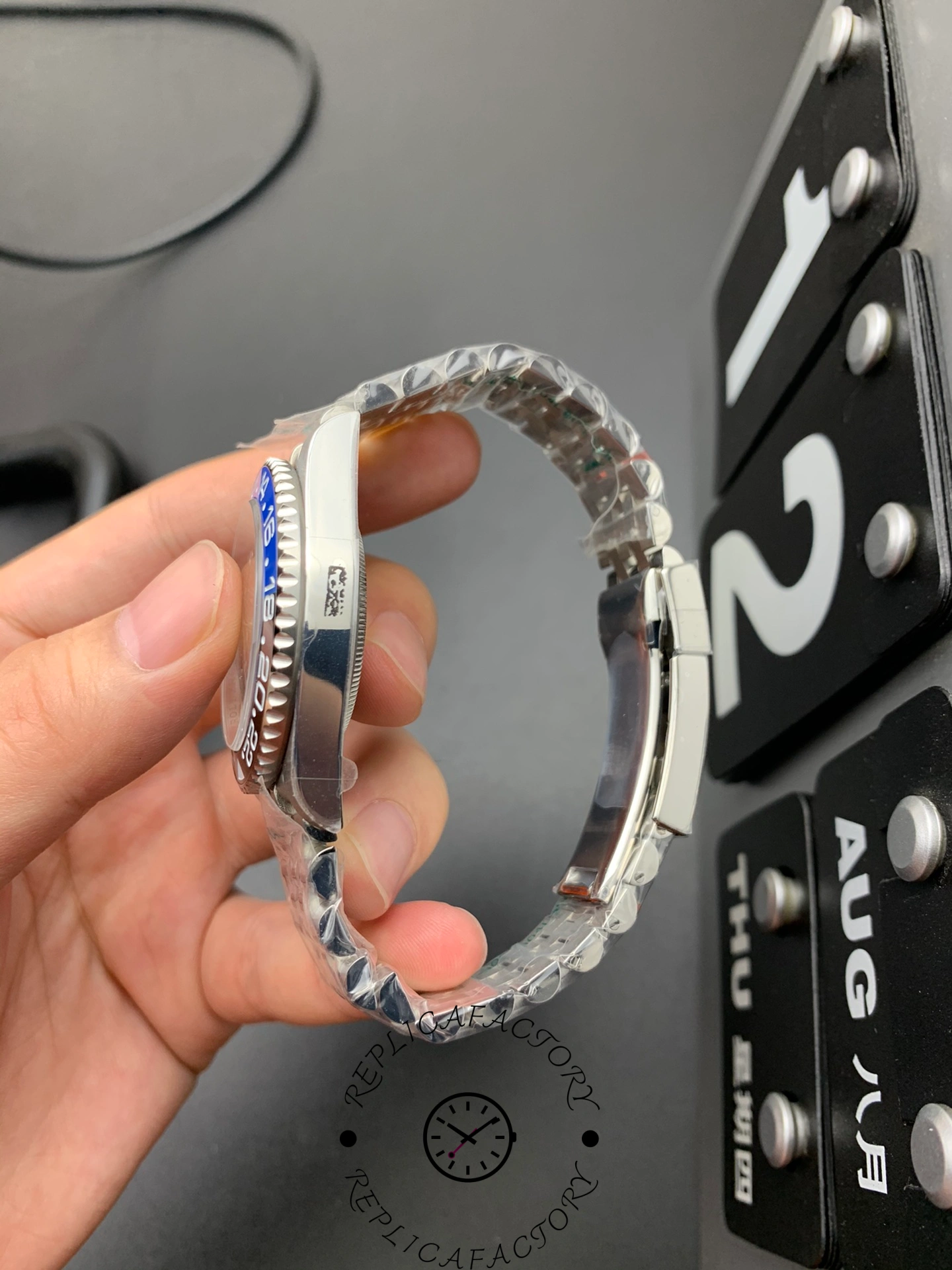 Rolex GMT-Master II 126710BLNR side view in hand, case profile and bezel edge.