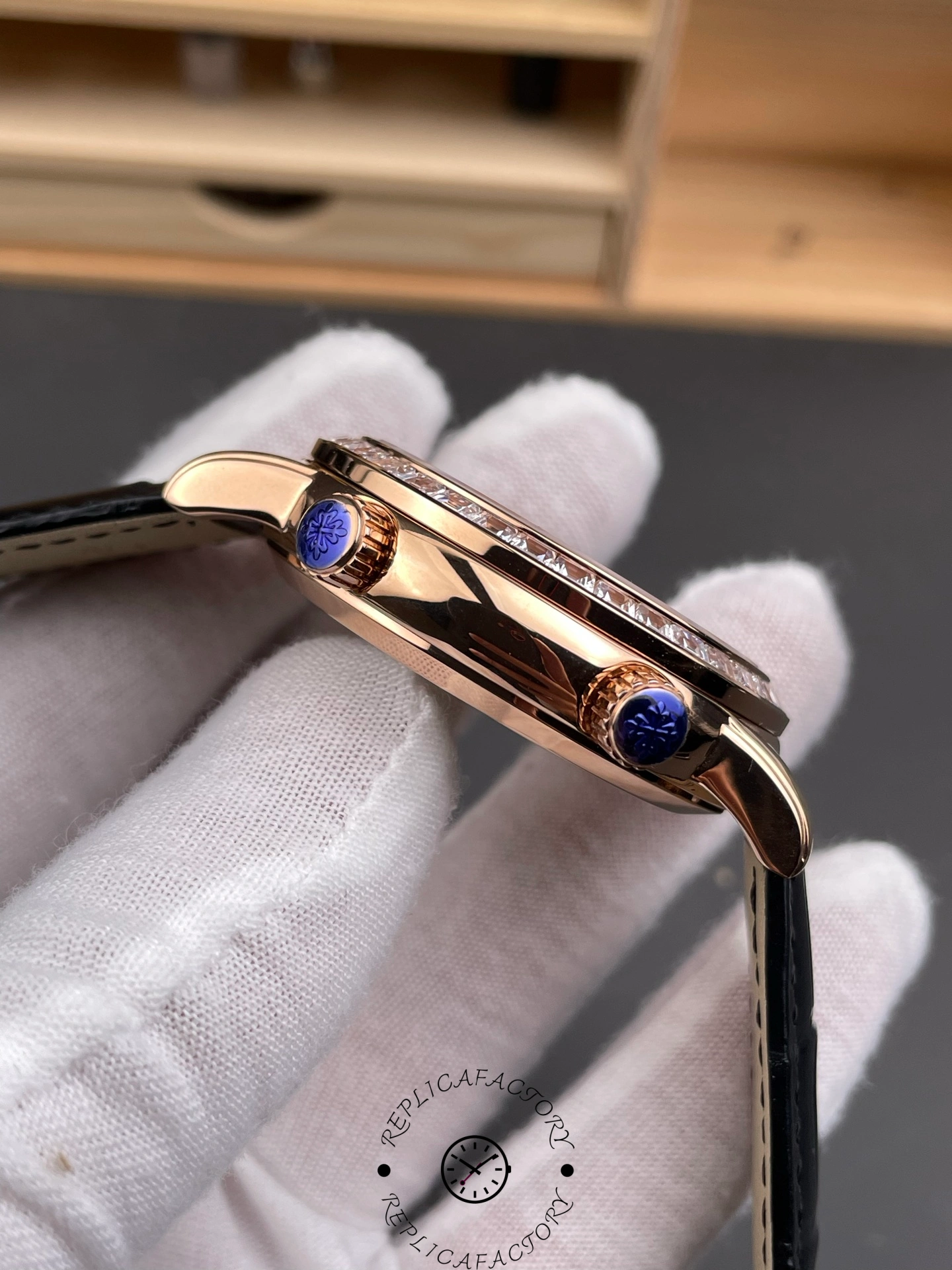 Thin side view of Patek Philippe 6104R 001 highlighting polished rose gold case edge and crown.