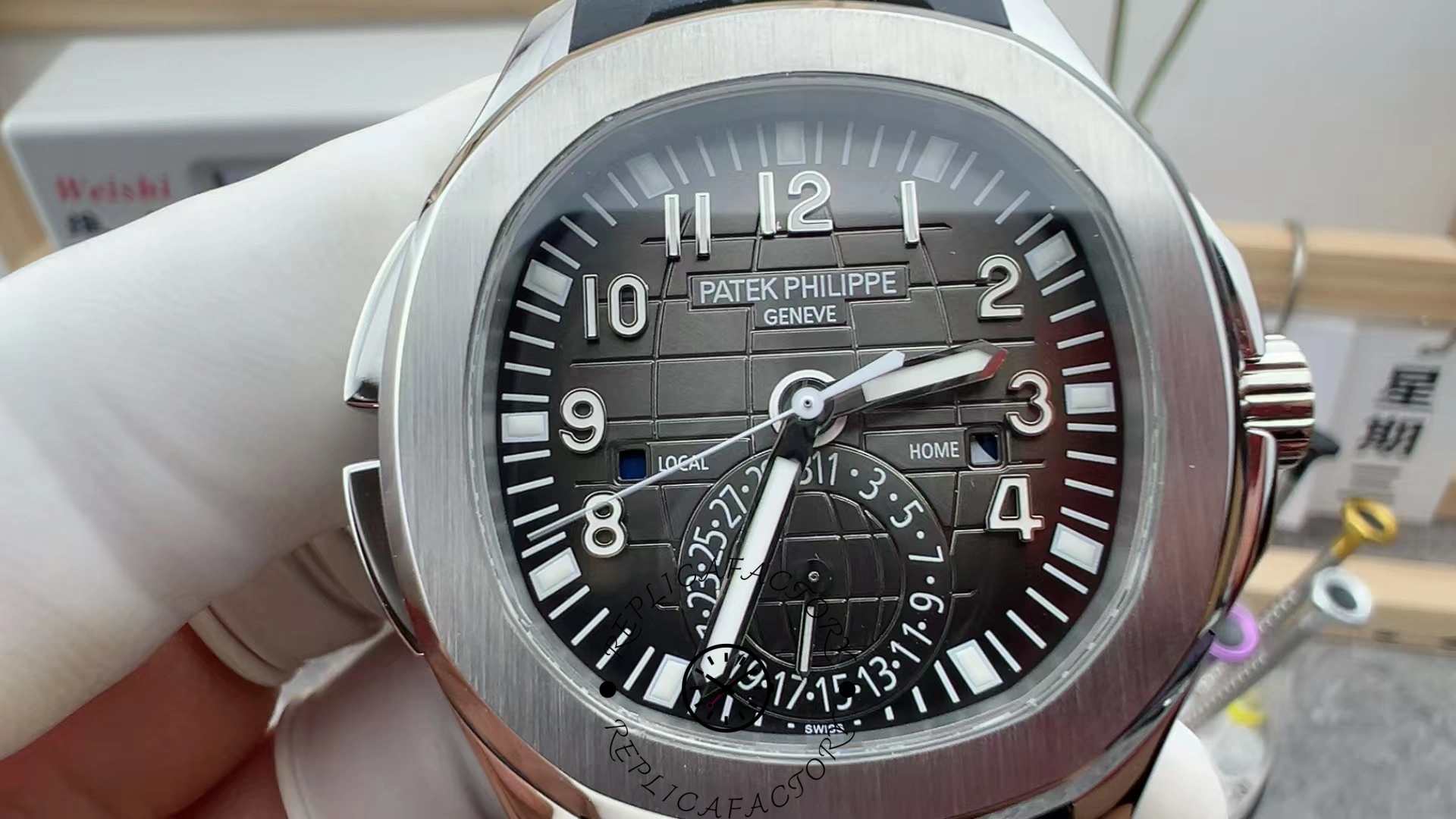 Close-up of the Patek Philippe Aquanaut 5164A-001 dial, Arabic numerals and dual time indicators.