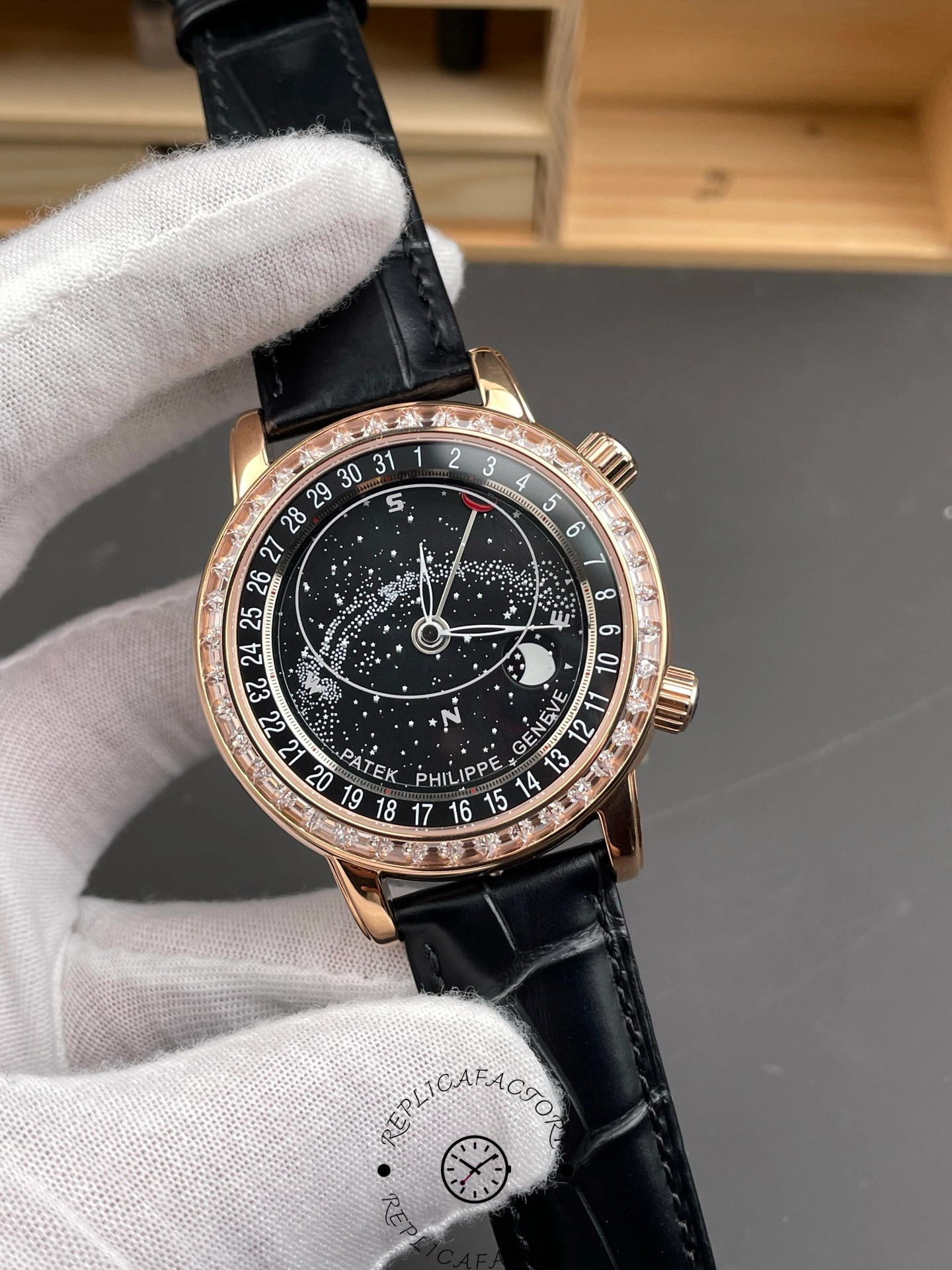 Close angled shot of Patek Philippe 6104R 001 with celestial dial details and Arabic numerals.
