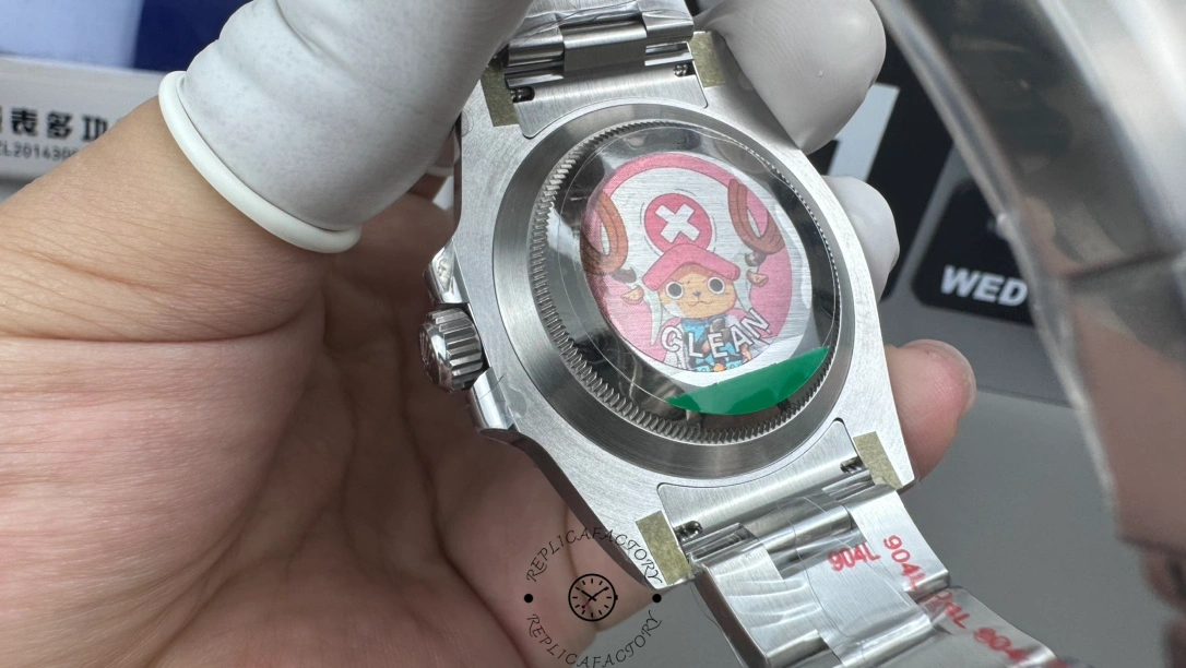 Rolex Submariner 116610LV, caseback view in hand, stainless steel back.