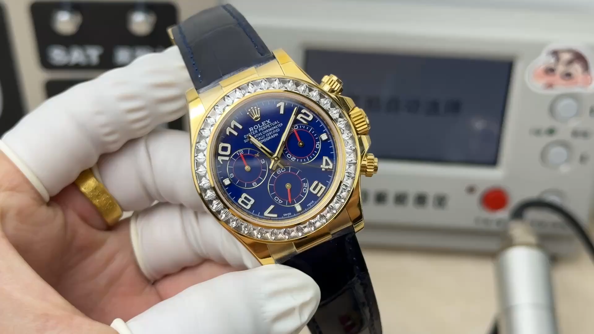 Rolex Daytona 116518 Diamond Edition, video with watch held in hand and black strap visible. - Video
