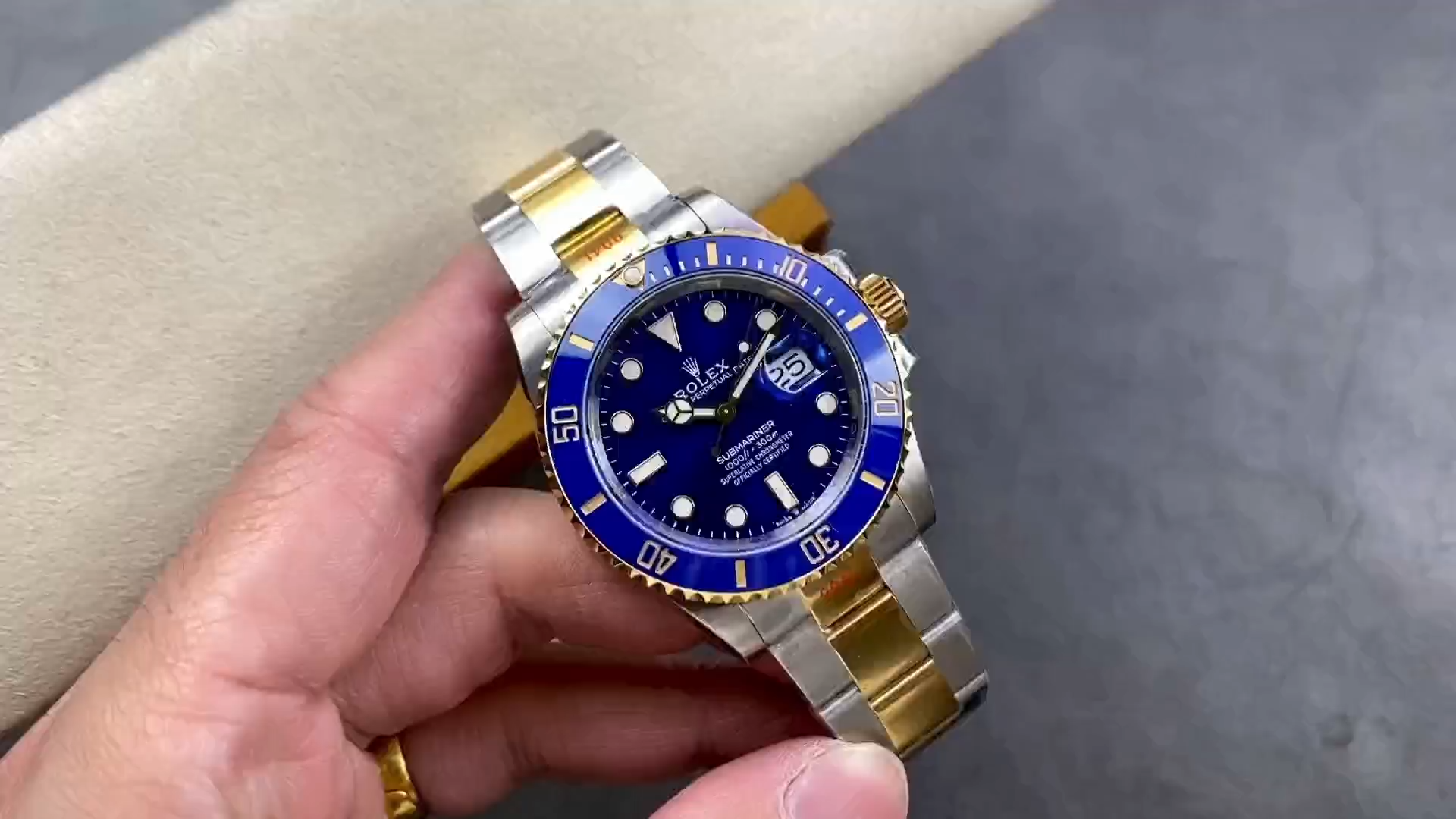 Rolex Submariner 126613LB in hand, blue dial close view with date window and cyclops lens. - Video
