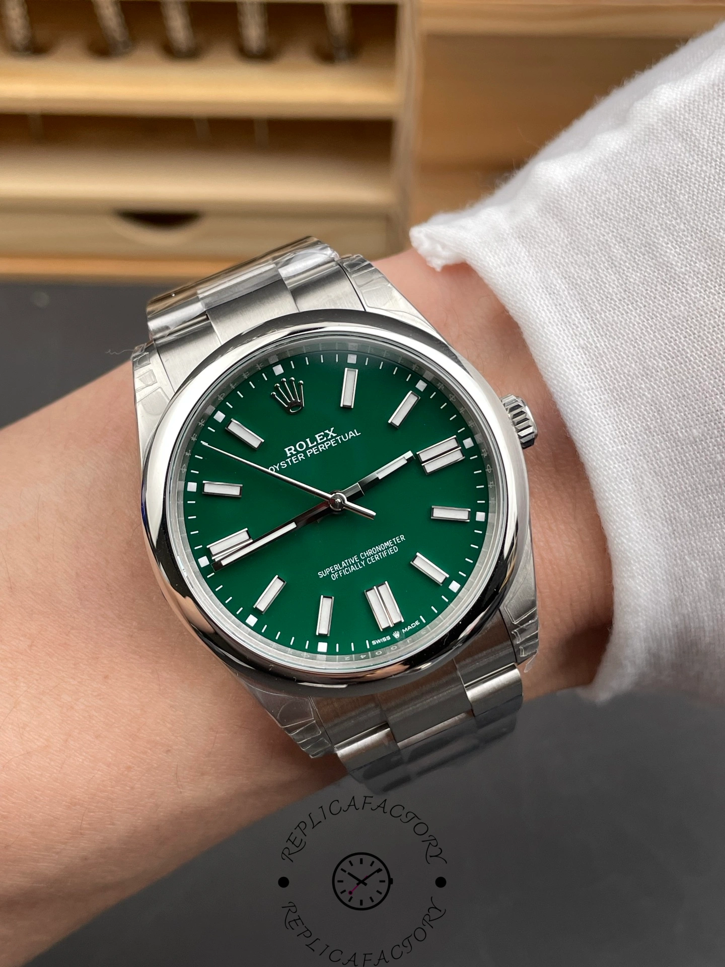 Wrist shot of Rolex Oyster Perpetual 134300 0004 showing green dial wear effect.