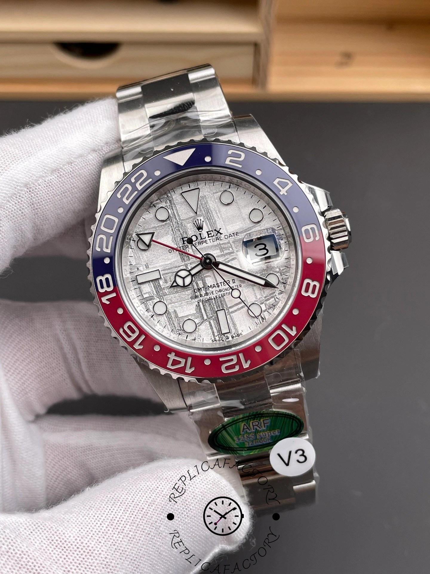 Rolex GMT-Master II 126719 0002 angled view in glove, meteorite dial, Pepsi bezel, bracelet.
