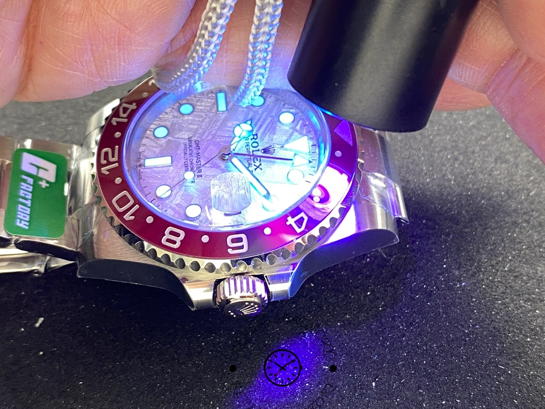 Rolex GMT-Master II 126719 0002 UV lume test shot, glowing markers and hands on dial.