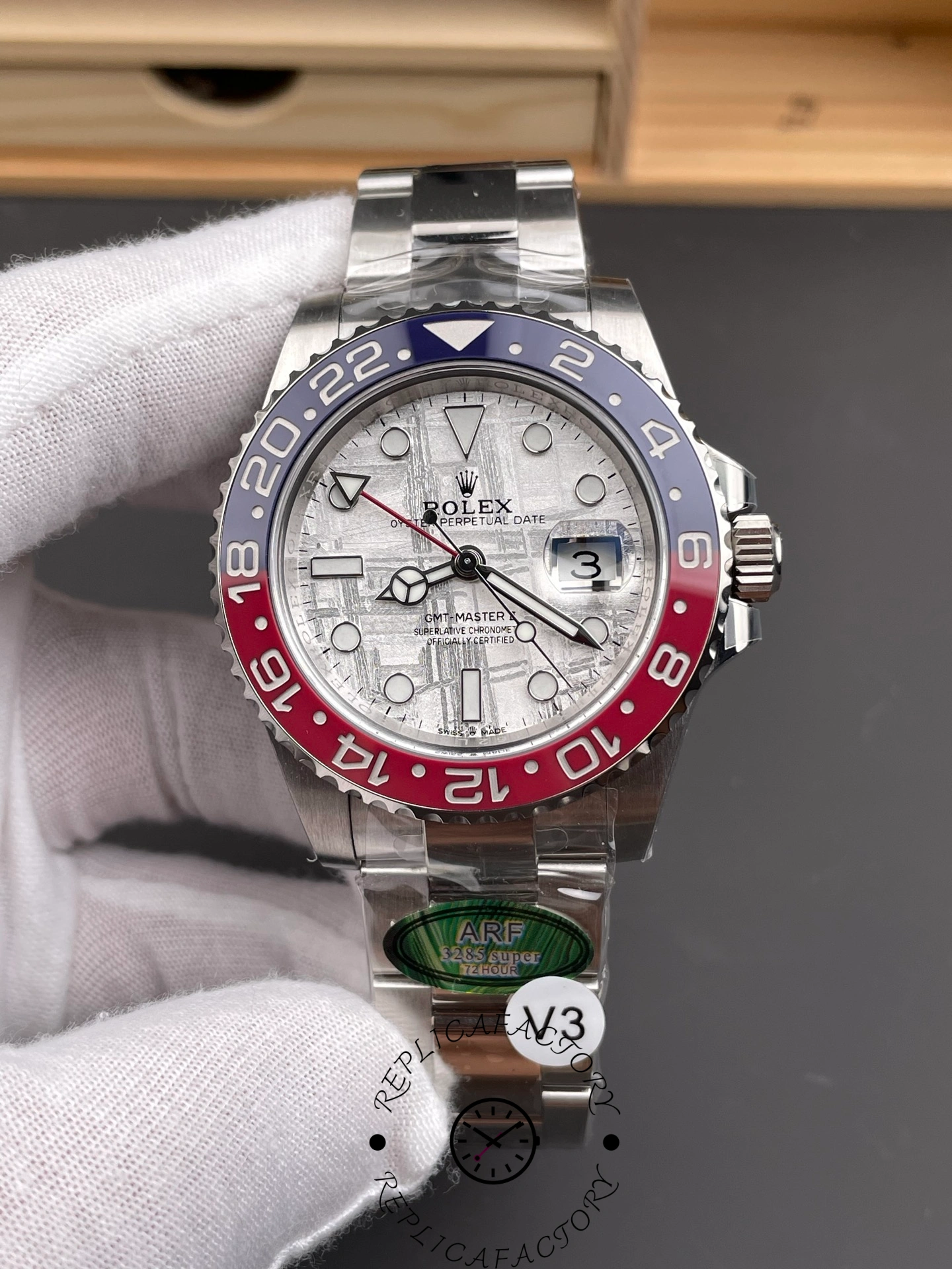Rolex GMT-Master II 126719 0002 held in glove, meteorite dial and Pepsi bezel, front view.