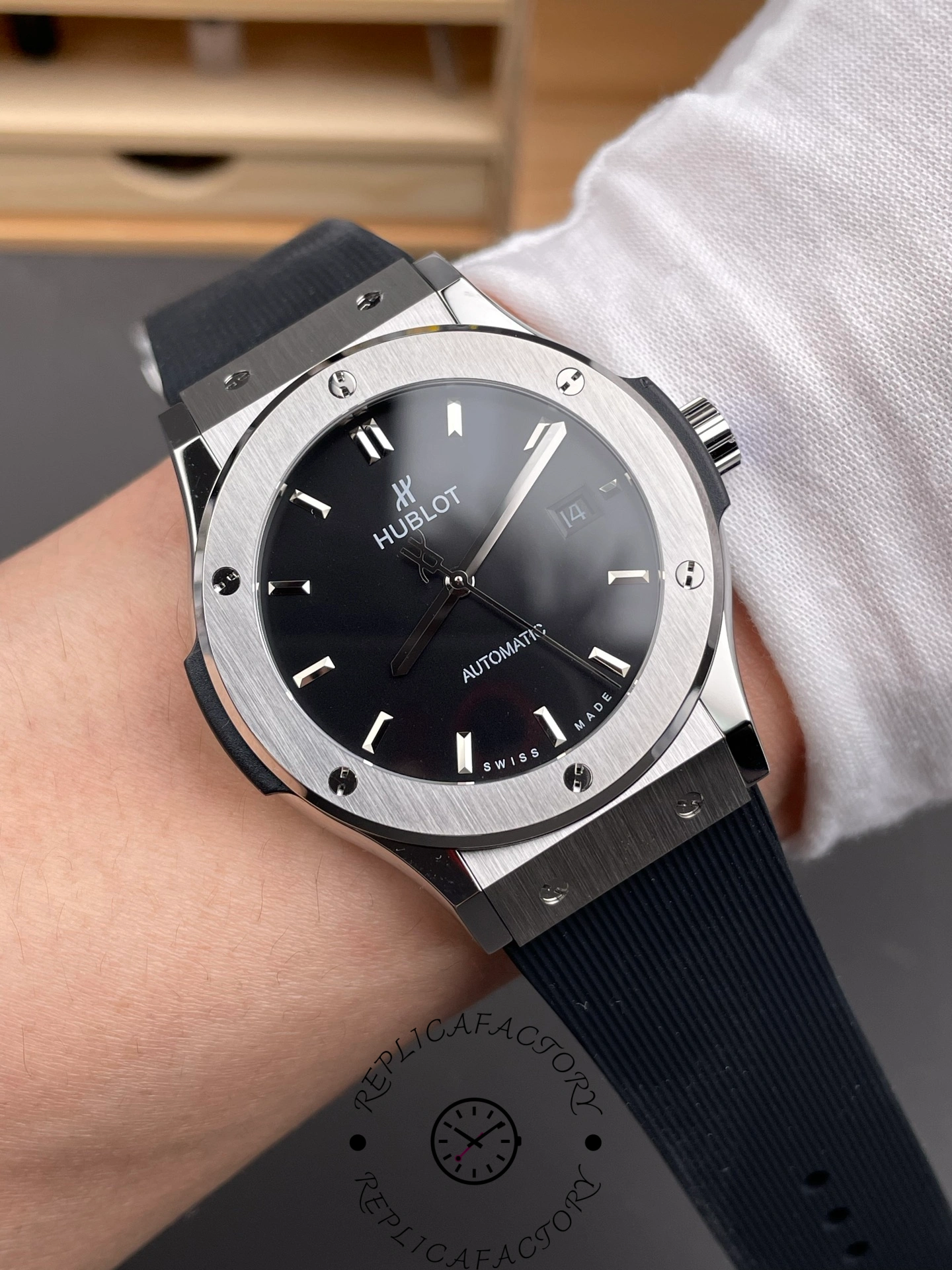 Wrist shot of the Hublot Classic Fusion 542.NX.1171.RX showing fit on wrist and black rubber strap.