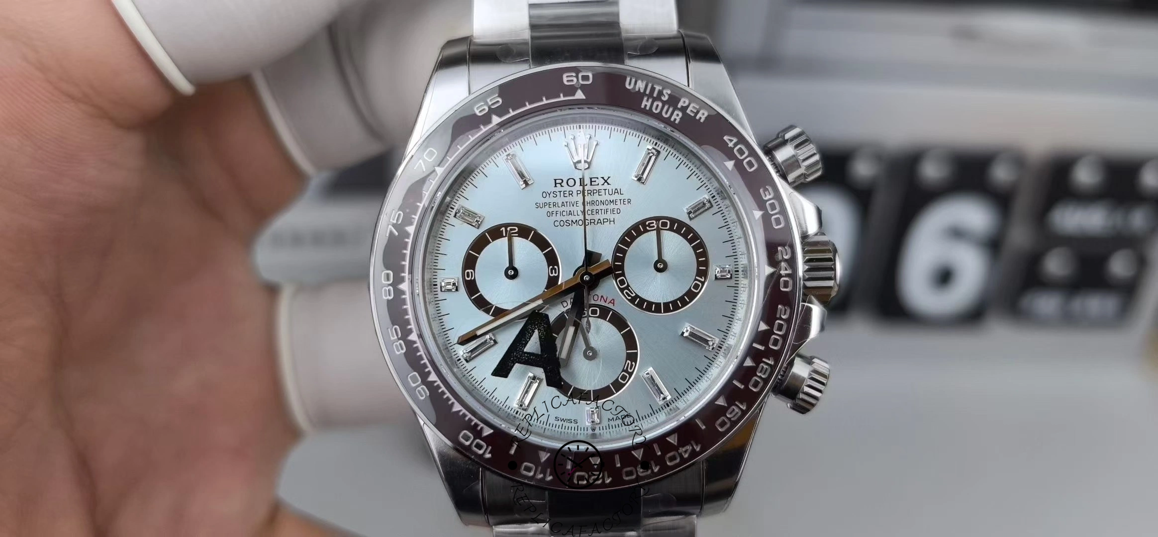 Hand-held front view of the Rolex Platinum Cosmograph Daytona 126506 0002 with ice blue dial.