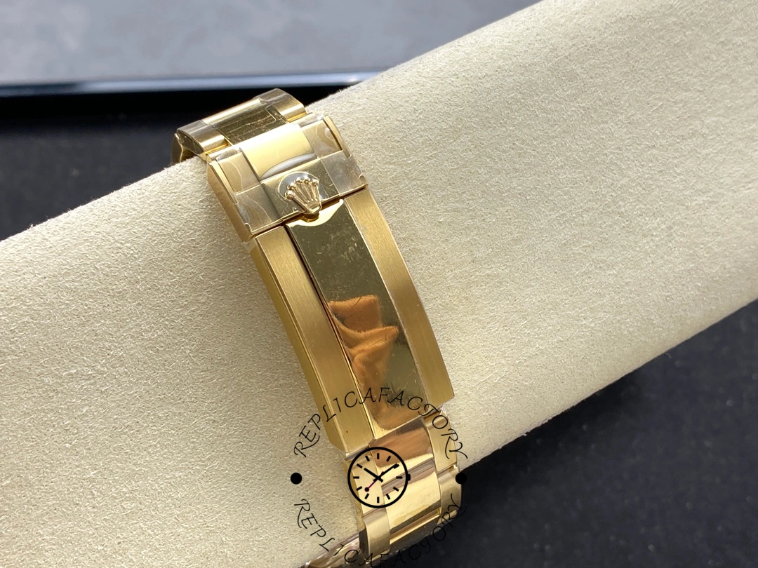 Rolex Deepsea 136668LB clasp close-up, yellow gold bracelet clasp and links, on cushion.