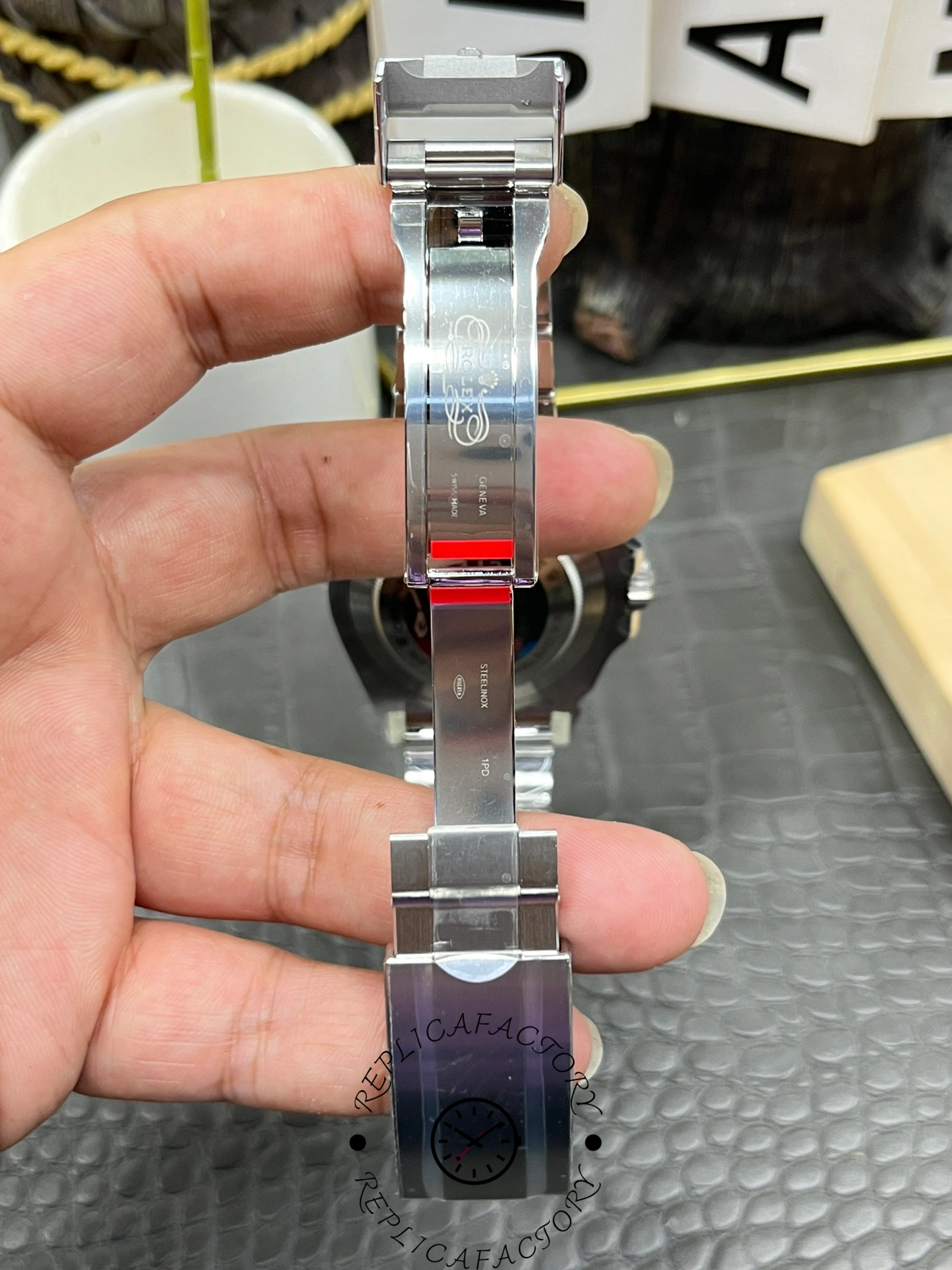 Rolex Sea-Dweller 126600 0002 bracelet back view, clasp and links, held in hand.