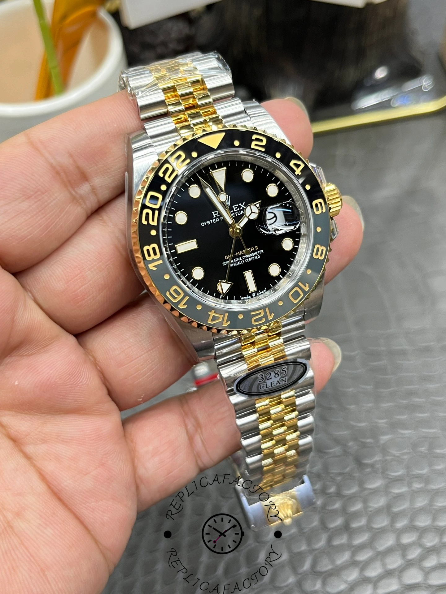 Handheld angled view of Rolex GMT-Master II 126713GRNR 0001 showing case and bracelet shine.